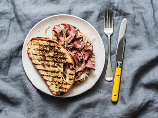 Medium rare beef steak ciabatta sandwiches with marinated onions and homemade mayonnaise mustard...