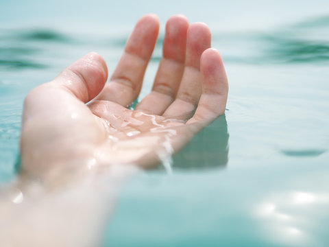 Hand in water.Sun glare on the water. Stock Photo | Adobe Stock