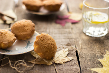 Sweet cupcakes on old wooden background.