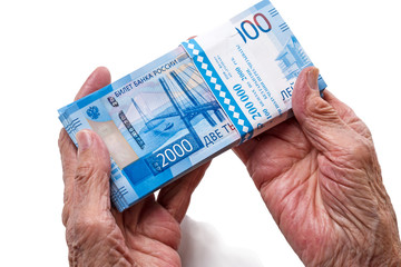 Old woman with Russian paper money 2000 rubles