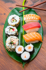 mixed sushi on green leaf