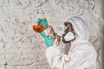 male researcher analyzing liquid reagent in laboratory glassware