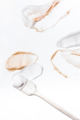 Smeared creme on white background. Dermatology and skincare. Beauty conception.
