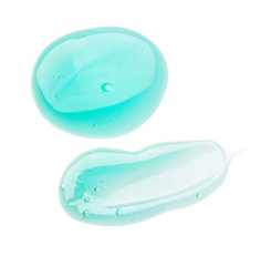 Smeared samples of creme and foundation and gel on white background.