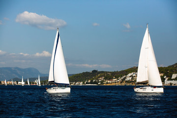 Obraz premium Sailing boats participate in sail yacht regatta around Saronic Islands in Aegean Sea - Greece.