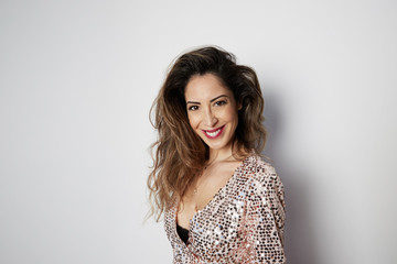 Fototapeta premium Beautiful excited women in shiny dresses dancing isolated over white background.