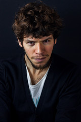 Obraz premium Curly man portrait on dark studio background