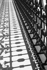 Fototapeta premium The shadow of the metal fencing bridge