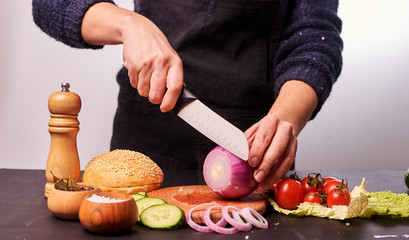 woman cutting vegetables in kitchen