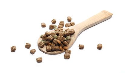 Dry dog food, granules with wooden spoon isolated on white background