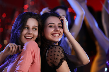 Beautiful young women dancing in night club