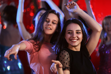 Beautiful young women dancing in night club