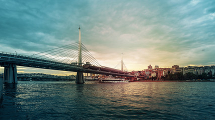 View of Golden Horn Metro Bridge (Halic Bridge) at sunset. Istanbul, Turkey.