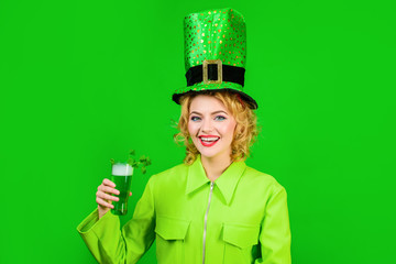 St Patrick's Day. Green top hat. Saint Patrick. Woman in top hat holds glass with green beer....