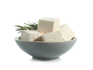 Bowl with tasty feta cheese on white background