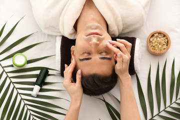 Man receiving face massage in beauty salon - Powered by Adobe