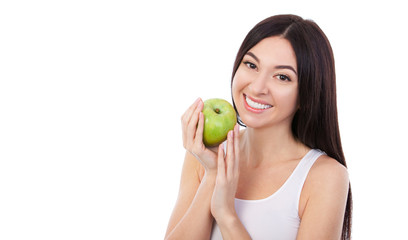 Cute woman with snow-white smile holding green apple. Healthy lifestyle and nutrition, dieting, weight loss, cosmetology, dental care and healthy teeth consept. Close up portrait of beautiful woman