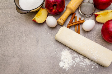 Apple pie ingredients baking concept. Fresh apples with cinnamon, flour, sugar, eggs. Cooking...