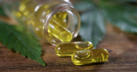 Macro close up of a jar with capsules of biological and ecological hemp plant herbal pharmaceutical...