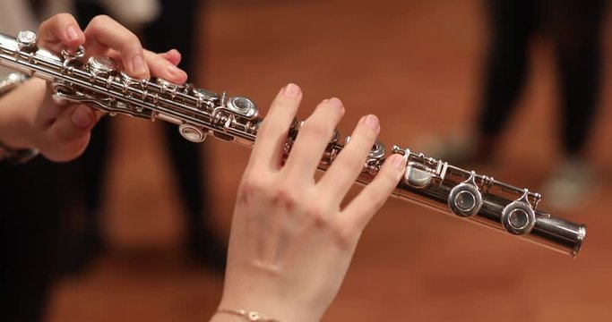 playing side-blown flute, transverse flute, cşassical music orchestra