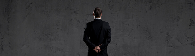 Businessman over dark background. World map background. Business, globalization, capitalism concept.