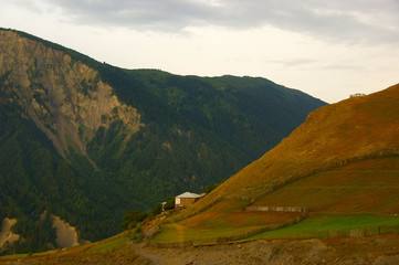 house in the mountains. lonely house with a piece of land, high in the mountains