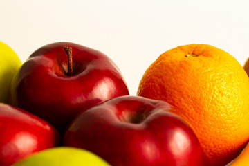 red green apples with ripe bananas and kiwi orange lemon on a white background