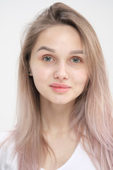 Naklejka premium Close-up of the face of a beautiful young blonde girl with smooth skin.