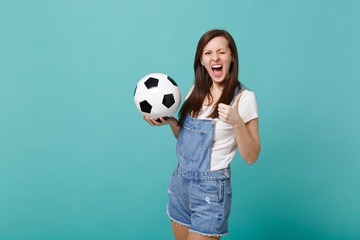 Blinking woman football fan cheer up support favorite team with soccer ball showing thumb up...