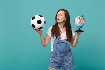 Puzzled young girl football fan support favorite team with soccer ball, Earth world globe isolated...