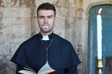 Spooky handsome priest with fangs