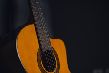 Fototapeta na wymiar yellow guitar with black background