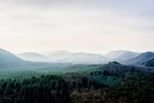 Panoramic view of the mountains against cloudy blue sky on a sunny winter day. Parc Naturel R&eacute;gional des Vosges du Nord. France, Lorraine