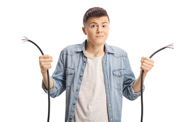 Confused young boy holding a broken cable