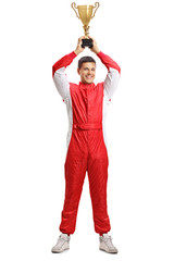 Male car racer holding a gold trophy cup above his head