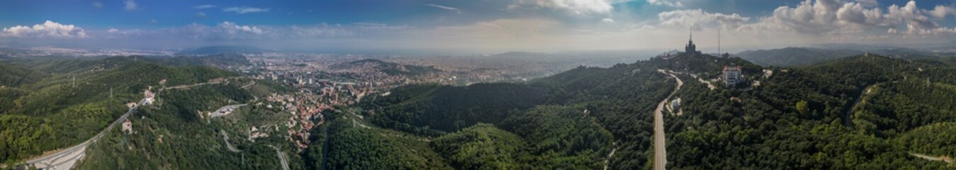 Aerial panoramic view of Barcelona and Tibidabo hills at sunny summer day