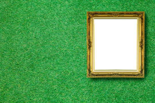 Vintage picture frame on green grass background.