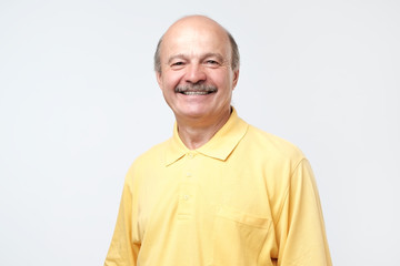 man grinning at funny story hiding pain. Not natural smile concept