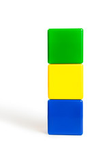 flag colors of Gabon: green, yellow, blue in the form of children's cubes. On white background...