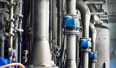 Large industrial water treatment and boiler room. Piping, servo butterly vlaves, flanges, pressure vessels