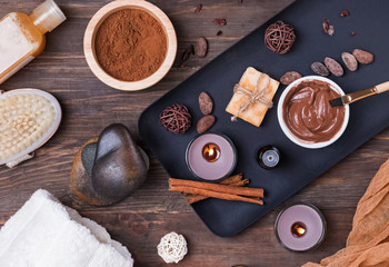 Chocolate spa set on the wooden background, top view.