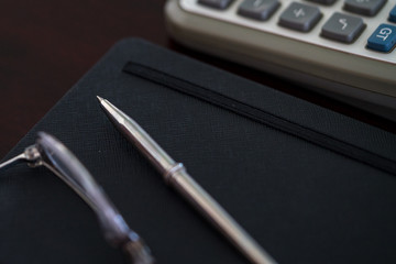 pen notebook and calculator