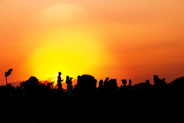 silhouettes of people taking pictures with smartphone