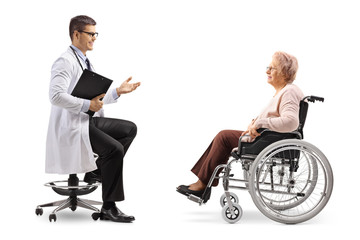 Male doctor talking to a mature female patient in a wheelchair
