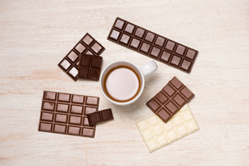 A lot of variety chocolates bar in box on white wooden background
