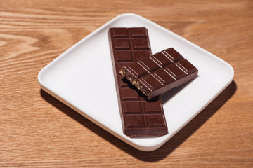 A lot of variety chocolates bar in box on white wooden background