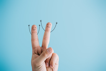 cropped view of joyful human fingers isolated on blue