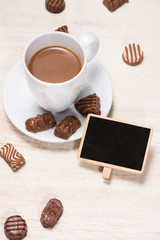 Glass of chocolate milk and variety chocolates  on table
