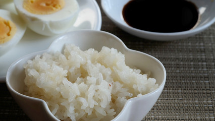Sticky rice or glutinous rice and boiled eggs served in restaurant, high vitamin, mineral such as selenium, copper and phosphorous food useful for human growth, tradition Thai food and export product