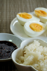 Sticky rice or glutinous rice and boiled eggs served in restaurant, high vitamin, mineral such as selenium, copper and phosphorous food useful for human growth, tradition Thai food and export product